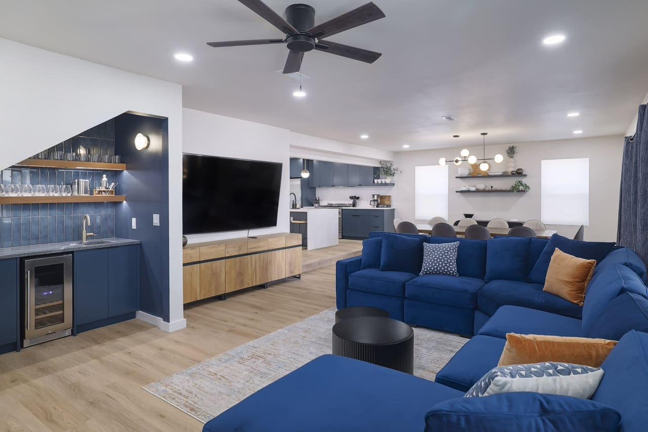 Austin East Bird living room with navy sectional and wet bar